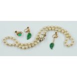 A SINGLE ROW NECKLACE OF CULTURED PEARLS, A PAIR OF EARRINGS AND ONE EARRING (3)