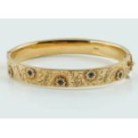 A VINTAGE GOLD BANGLE WITH SAPPHIRES