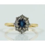 A GOLD AND PLATINUM, SAPPHIRE AND DIAMOND NINE STONE OVAL CLUSTER RING