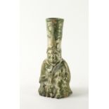 A CHINESE POTTERY GREEN GLAZED FIGURAL CANDLE HOLDER