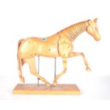 A 20TH CENTURY BEECH ARTIST'S LAY HORSE FIGURE