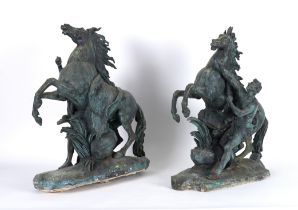 AFTER GUILLAUME COUSTOU THE ELDER (1677-1746): A PAIR OF PATINATED BRONZE MODELS OF THE MARLY...