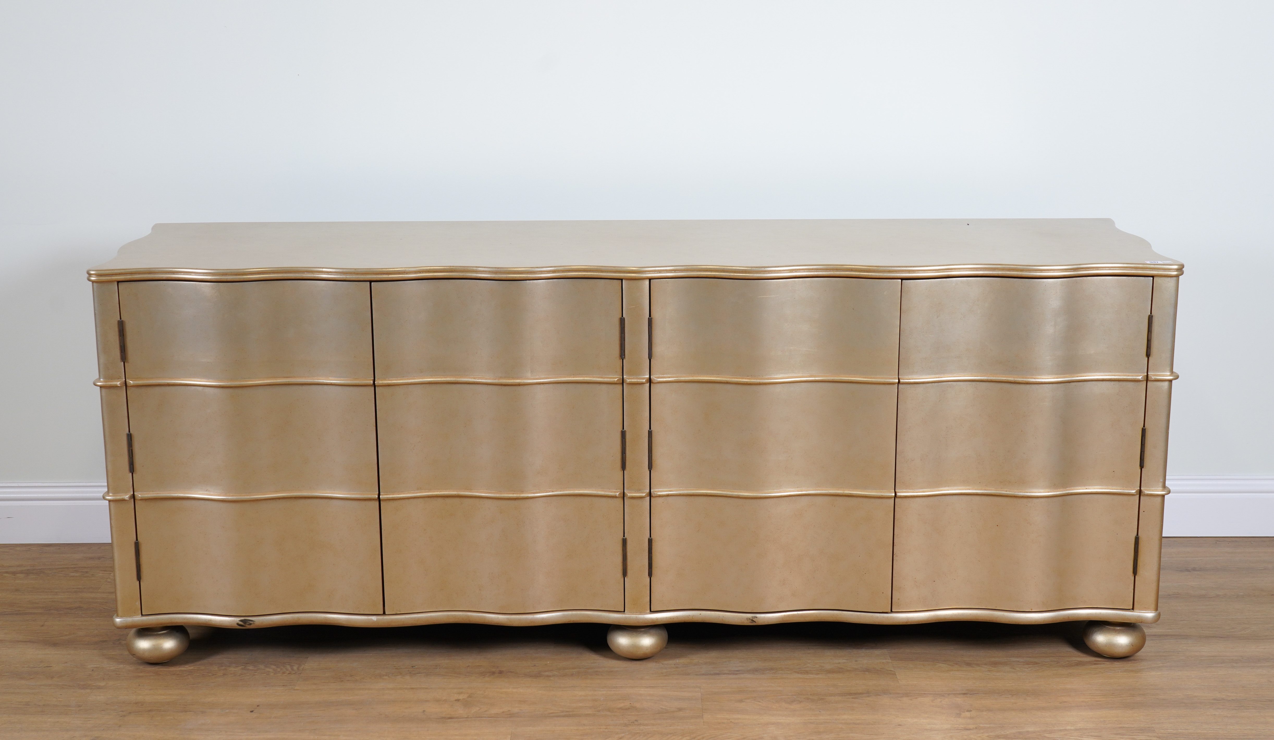 PAUL MARTIN; A GOLD PAINTED WAVY FRONTED FOUR DOOR LOW CABINET - Image 2 of 4