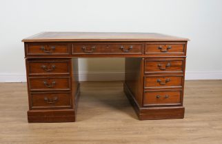 A MAHOGANY NINE DRAWER PEDESTAL DESK