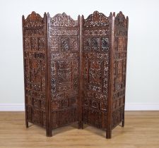 AN EARLY 20TH CENTURY EASTERN CARVED TEAK FOUR FOLD SCREEN