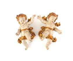 AN OPPOSING PAIR OF SOUTH GERMAN / AUSTRIAN BAROQUE PARCEL-GILT POLYCHROME WINGED PUTTI (2)