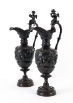 A PAIR OF FRENCH BRONZE RELIEF CAST ORNAMENTAL EWERS IN THE MANNER OF CLODION (2)