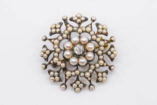 A LATE VICTORIAN GOLD BACKED AND SILVER SET DIAMOND AND SEED PEARL BROOCH