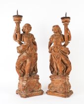 A PAIR OF ITALIAN LIMEWOOD FIGURAL PRICKET CANDLESTICKS (2)