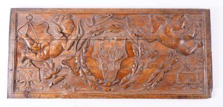 AN 18TH CENTURY CONTINENTAL CARVED POPLAR PANEL DEPICTING WINGED CHERUBS