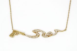 A STEPHEN WEBSTER 18CT GOLD AND DIAMOND SMOKING GUN NECKLACE