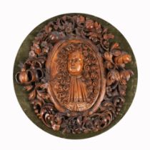 A CHARLES II CARVED LIMEWOOD PORTRAIT PLAQUE