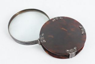 A SILVER AND TORTOISESHELL MOUNTED CIRCULAR FOLDING MAGNIFYING GLASS