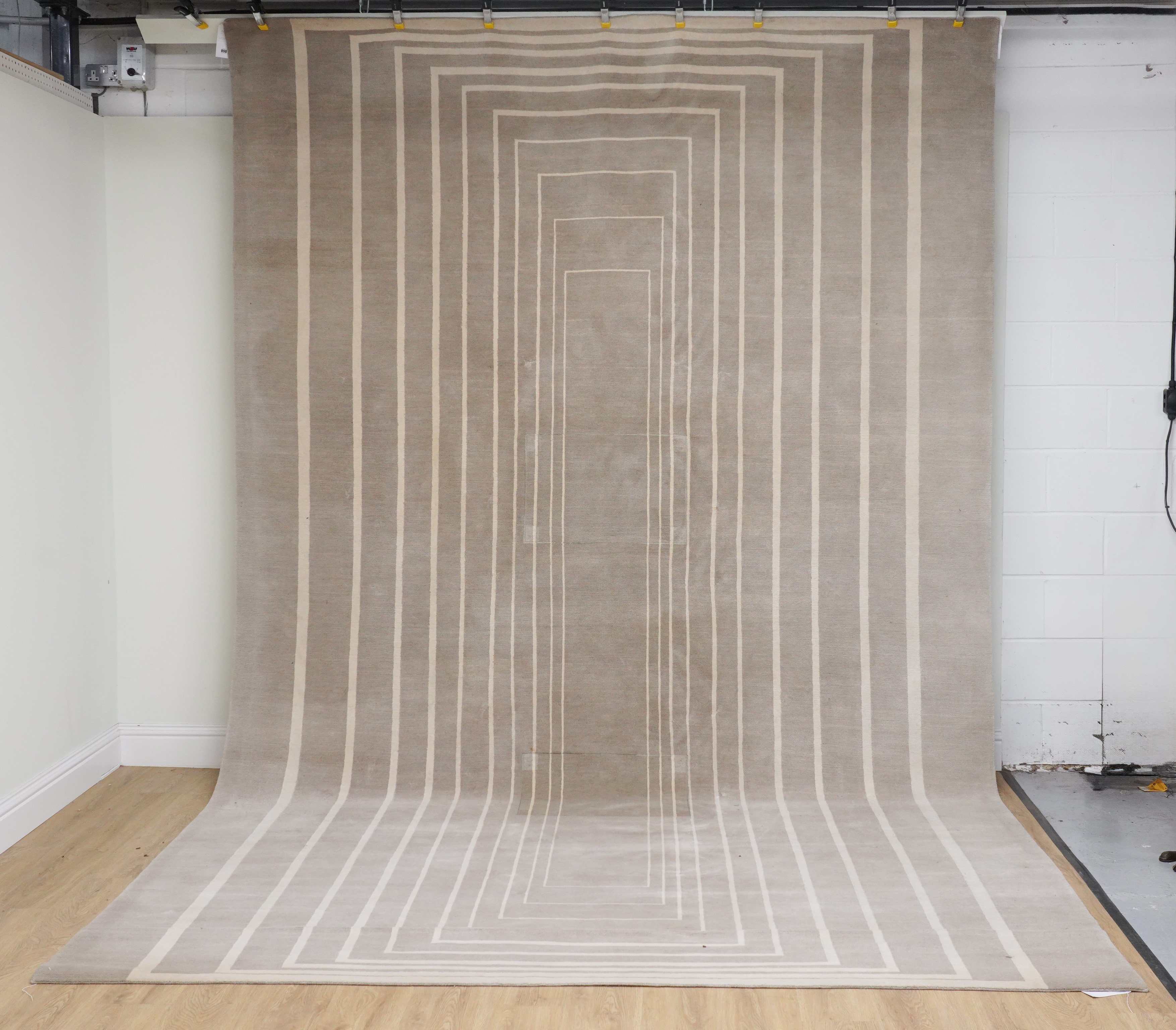 A MODERN LARGE GREY RECTANGULAR CARPETwith concentric ivory rectangles ...