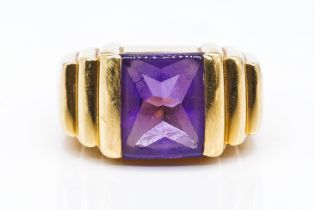 A GOLD AND AMETHYST SINGLE STONE RING