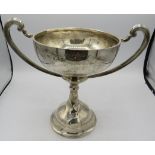 A large two handled silver golfing trophy. Chester 1934. Approx: 9" high, 28 troy oz/883 grams.