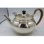 A good quality Victorian silver teapot with wicker handle. London 1852. Thomas's Bond Street. 21.4