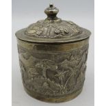 A white metal round lidded Indian box. Embossed with trees, houses and temples. 4.6 troy oz/142