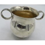 A pot bellied silver mug with 2 circular ring handles. Chester 1904. 6.4 troy oz/200 grams.