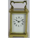 A brass cased 8 day carriage clock with enamel dial. Overall height: 15cm . No key. Condition