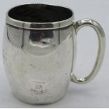 A silver barrel shaped christening mug with 'C' shaped handle. Approx: 3" high. London 1922.