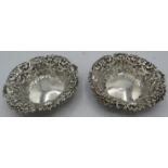 A pair of circular silver bon bon dishes with pierced sides and mask and foliate embossed