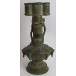 An antique Chinese bronze vase in the Archaic style decorated with dragons and with lion mask