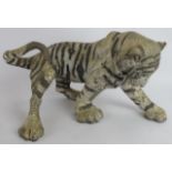 A glazed pottery figure of a tiger cub by Keza Rudge, signed. Length 41cm. Height 23cm. Condition