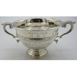 A small two handled pedestal silver trophy engraved 'Replica B.G.C. 1932'. Approx: 2 1/2" high.