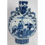 An antique Chinese porcelain moon vase with blue and white decoration and dragon handles. Height