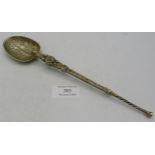 A large engraved white metal anointing spoon. Condition report: Some wear.