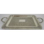 A fine white metal Indian tray with embossed foliate design. Approx: 17" x 12" excluding carrying