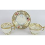 An early 19th century porcelain trio of saucer, tea and coffee cups, each with cottage scene