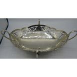 A large oval silver dish with four handles terminating in pad feet. Pierced decoration. Approx: