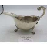 A silver sauce boat with double scroll handle and paw feet. Birmingham 1932 Mappin & Webb. 2.5