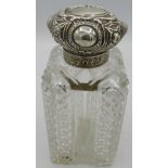 A large heavy cut glass silver topped scent bottle with inner stopper. Approx: 7" high. London 1898.