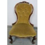 A Victorian walnut spoon-back nursing chair, upholstered in buttoned caramel velvet material with