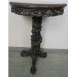 A 19th century Chinese rosewood circular occasional table, with inset red marble top above a foliate