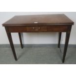 A Georgian mahogany turnover tea table, strung with satinwood, the central drawer with brass swan-