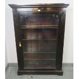 A Victorian mahogany ebonised glazed bookcase, flanked by reeded columns, housing four height