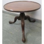 A Georgian mahogany low circular occasional table, on a turned column with splayed tripod supports