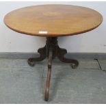 A Georgian walnut circular wine table with shell inlay, on a baluster turned column with scrolled