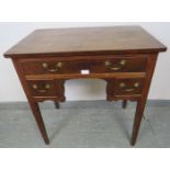 A Georgian mahogany lowboy, housing one long and two short cock-beaded drawers with gilt brass