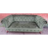 A Victorian Chesterfield sofa, upholstered in green velvet buttoned material with braided rope trim,