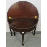 A Georgian Cuban mahogany demi-lune turnover tea table, with shell carved knees, on tapering