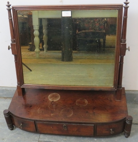 A George III mahogany swing vanity mirror, on a bow-fronted box base housing three drawers,