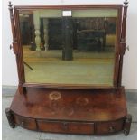 A George III mahogany swing vanity mirror, on a bow-fronted box base housing three drawers,