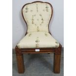 A small Victorian walnut spoon-back chair, reupholstered in a contemporary buttoned material, on