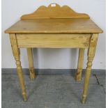 An antique stripped pine washstand with shaped gallery, on tapering front supports and square rear