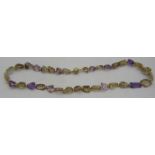 An amethyst & citrine laser cut necklace interspersed with small yellow metal beads, 14ct gold